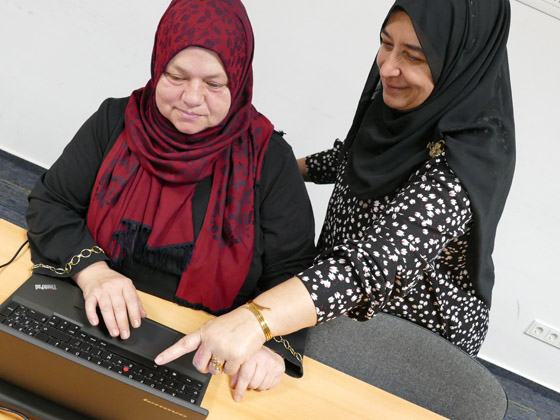 Zwei Frauen sitzen bzw. stehen an einer Computertatstatur (Quelle: © Stop press & public/Helmut Stapel) Zwei Frauen sitzen bzw. stehen an einer Computertatstatur
